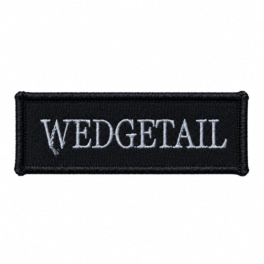 Black rectangular patch with embroidered silver ’wedgetail’ text