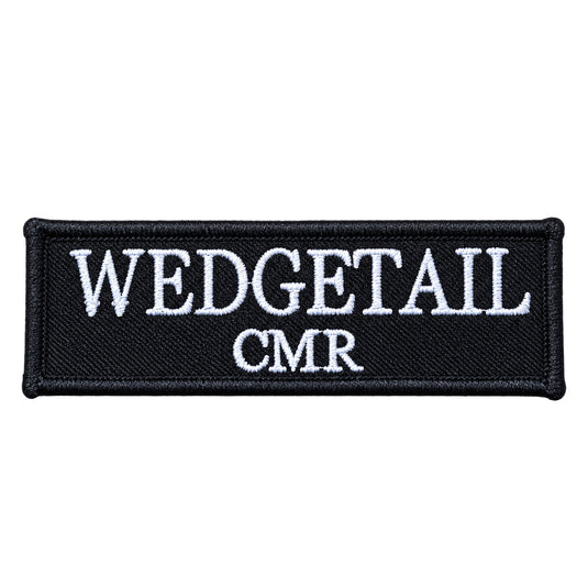 Black embroidered patch with white stitched text reading ’wedgetail’ above ’cmr’